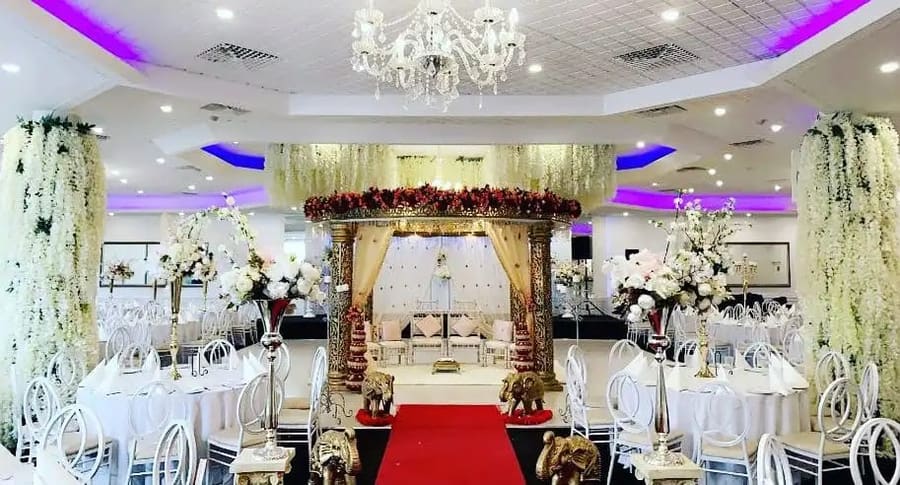 Red carpet aisle to a floral mandap