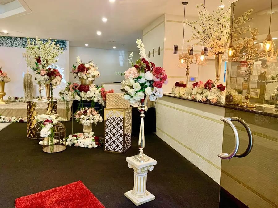 Florals and gold candelabras at the venue entrance