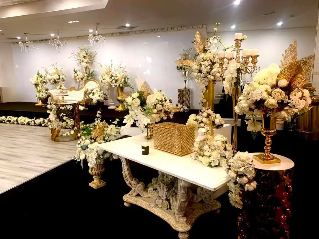 Gift table and floral stands in front of the stage