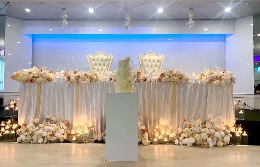 Throne chairs, white florals and candles at the head table