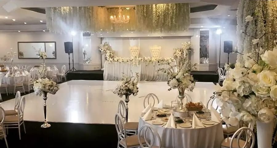 Round tables set beneath a hanging floral ceiling