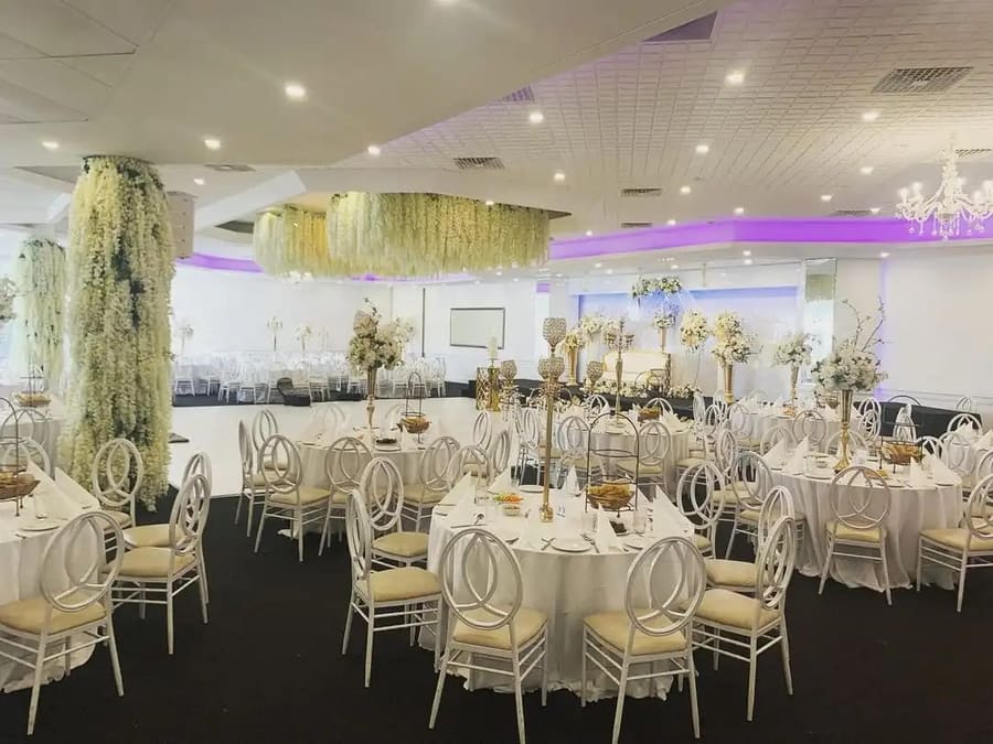 Room set with ring-back chairs under a hanging floral ceiling