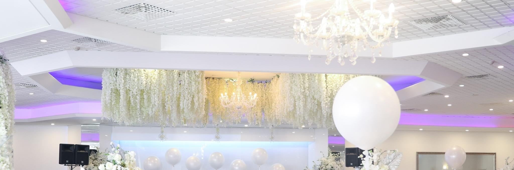 Hanging white wisteria and chandeliers over the function room