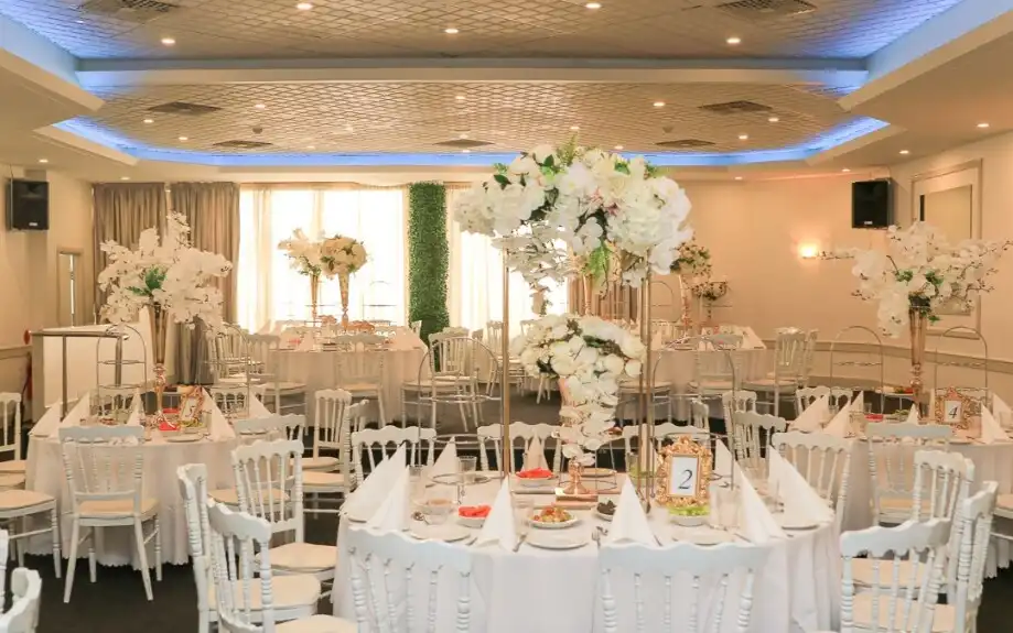 The Diamond Room set with round tables and tall white floral centrepieces