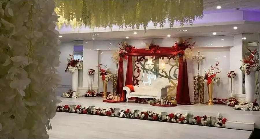 Red and gold mandap set on the dance floor